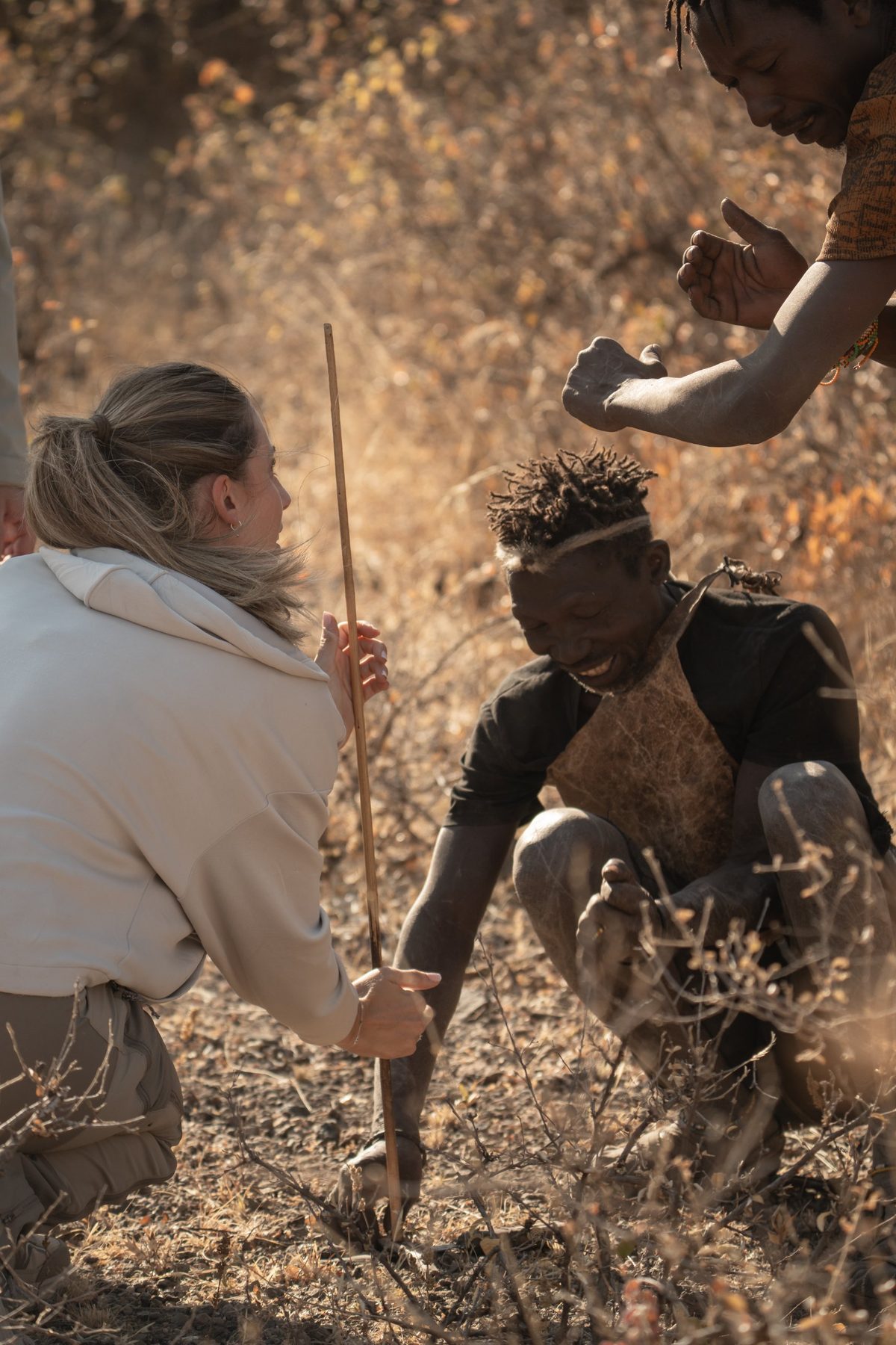A traveller learning bush skills with Hadzabe hunters