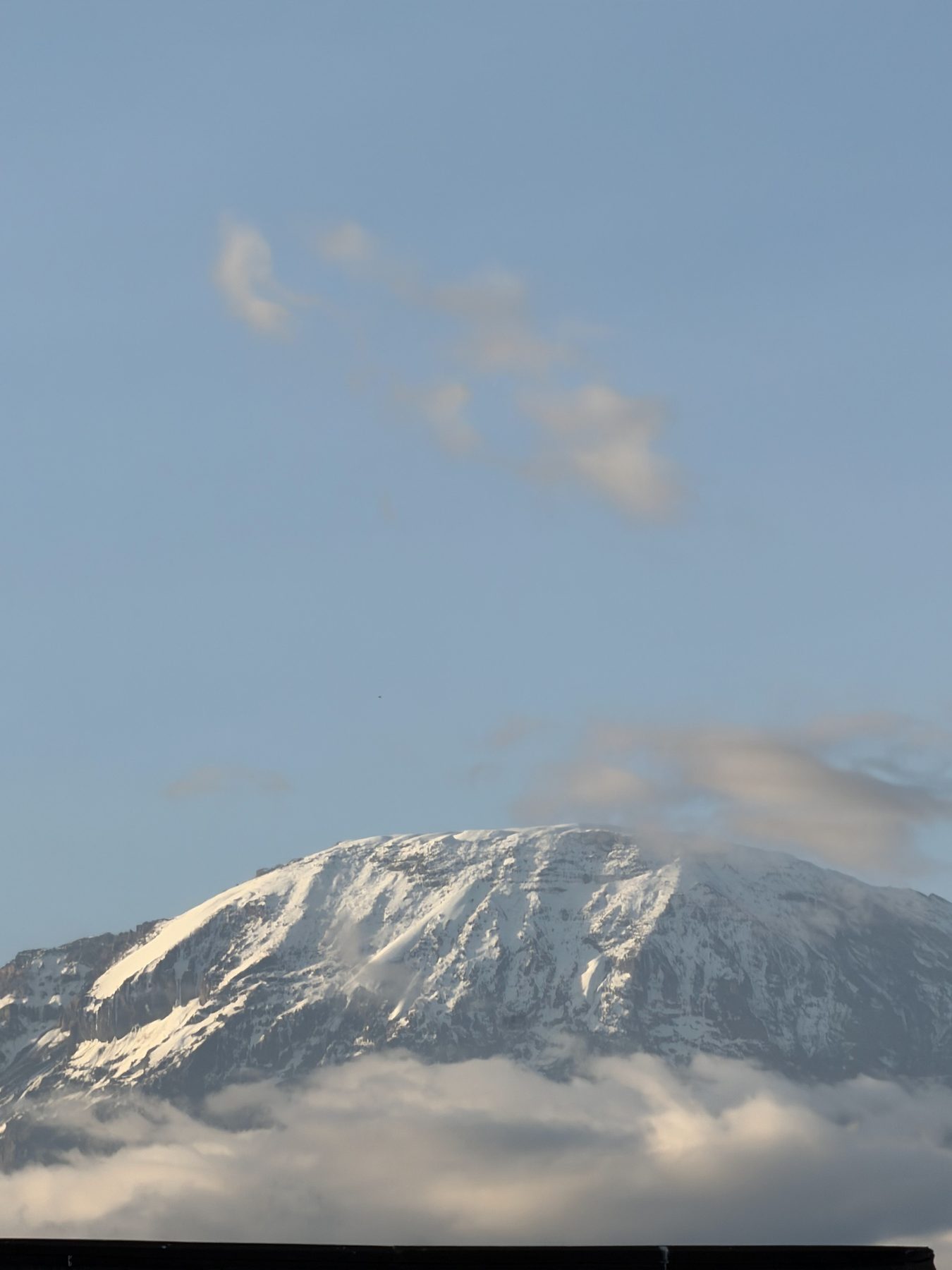 Snow-capped Kibo peak of Kilimanjaro above the clouds