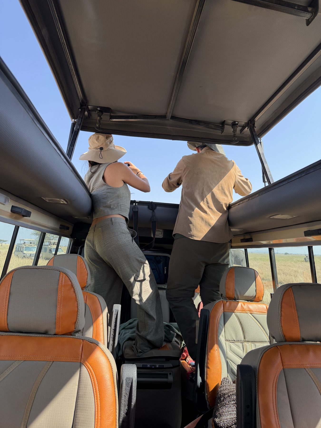 Viajeros de pie bajo el techo elevable abierto